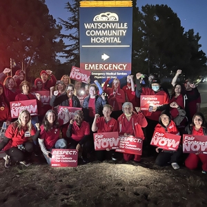 Large groups of nurses outside Watsonville Community Hospital holding signs "Fair Contract Now"