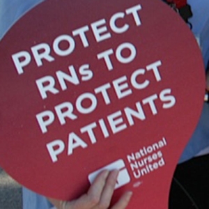 Nurses holding signs