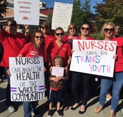 nurses holding signs in support of transgender youth