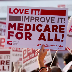 Nurse holding medicare for all sign