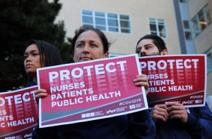 Nurses with protect signs