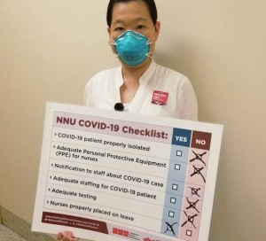 Nurse holding precaution demands sign