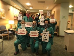 nurses holding signs