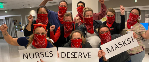 nurses holding signs