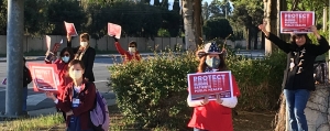 Nurses outside facility holding action