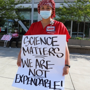 nurses holding signs