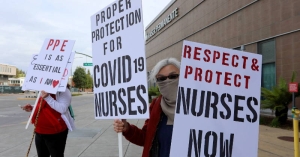 nurses holding signs