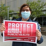 nurses holding signs