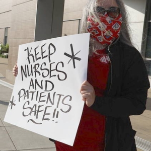 nurses holding signs