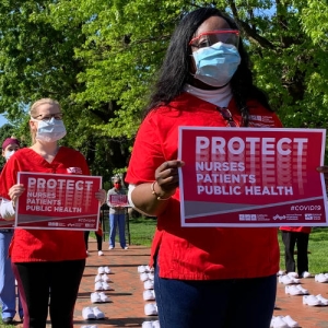 nurses holding signs outside White House 