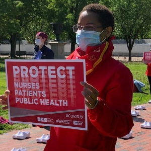 nurses holding signs