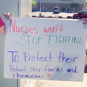 nurses holding signs