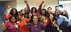 Large group of nurses with raised fists