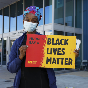 Nurse holds sign "Black Lives Matter"