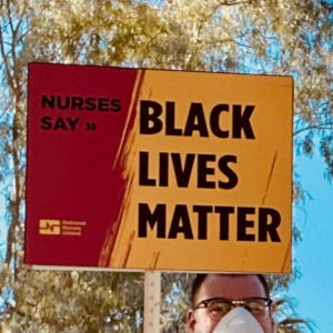 Nurses hold signs againt racism