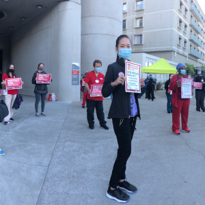 Nurse holds "Protect Nurses" signs