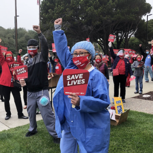 Nurses hold signs "Save Lives"