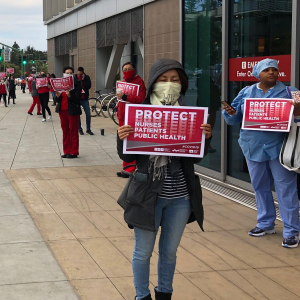 Nurses holding signs outside Enloe Medical Center