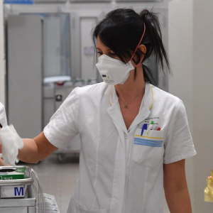 Nurses in masks putting on gloves