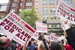 National Nurses United union members wave "Medicare-for-all" signs