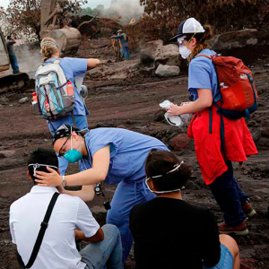 Nurses treat the eyes of people who continue to search for the remains of family members near Fuego volcano in Escuintla, Guatemala, in 2018