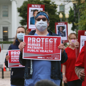 Nurses hold "Protect Nurses" signs outside the Whitehouse