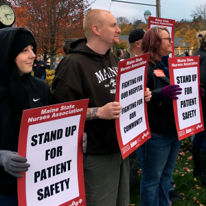Nurses from Northern Light Hospital in Maine hold signs for patient safety