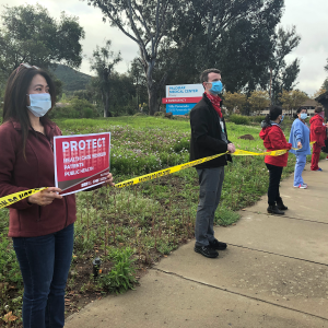 Nurses holding signs outside Palomar Health