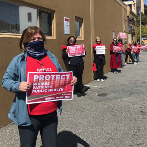 Nurses hold signs "Protect nurses"