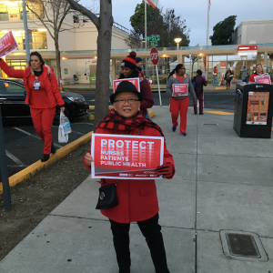 Nurse holds "Protect Nurses" signs