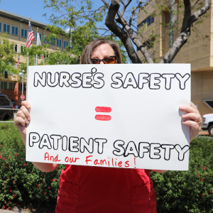 Nurses holds sign "Nurses safety = patient safety"