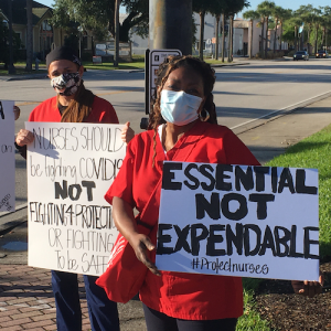 Nurses hold "Protect Nurses" signs