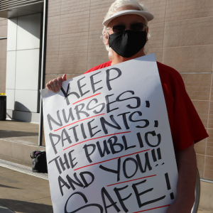 Nurse holding signs promoting public safety