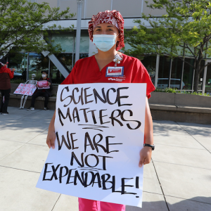 Nurse holds sign "Science matters"