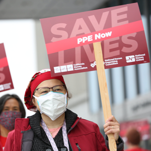 Nurses hold signs "Save Lives"