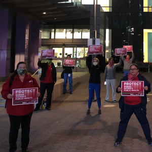 Nurse holds "Protect Nurses" signs