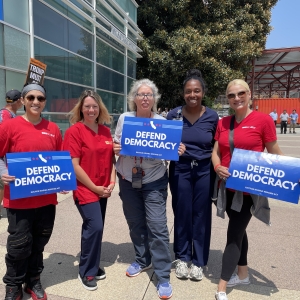 California nurses hold signs that read "Protect Democracy."