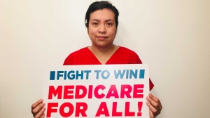 Nurse holding Medicare for All sign