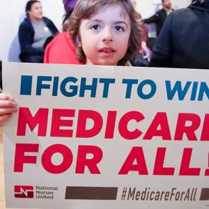 Girl holding medicare for all sign