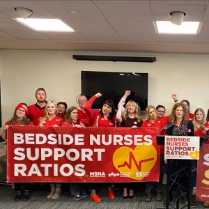 Maine nurses taking action for safe staffing, holding banner that reads "Bedside nurses support ratios!"