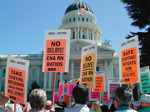 Signs outside California State Capitol building calling for safe staffing ratios