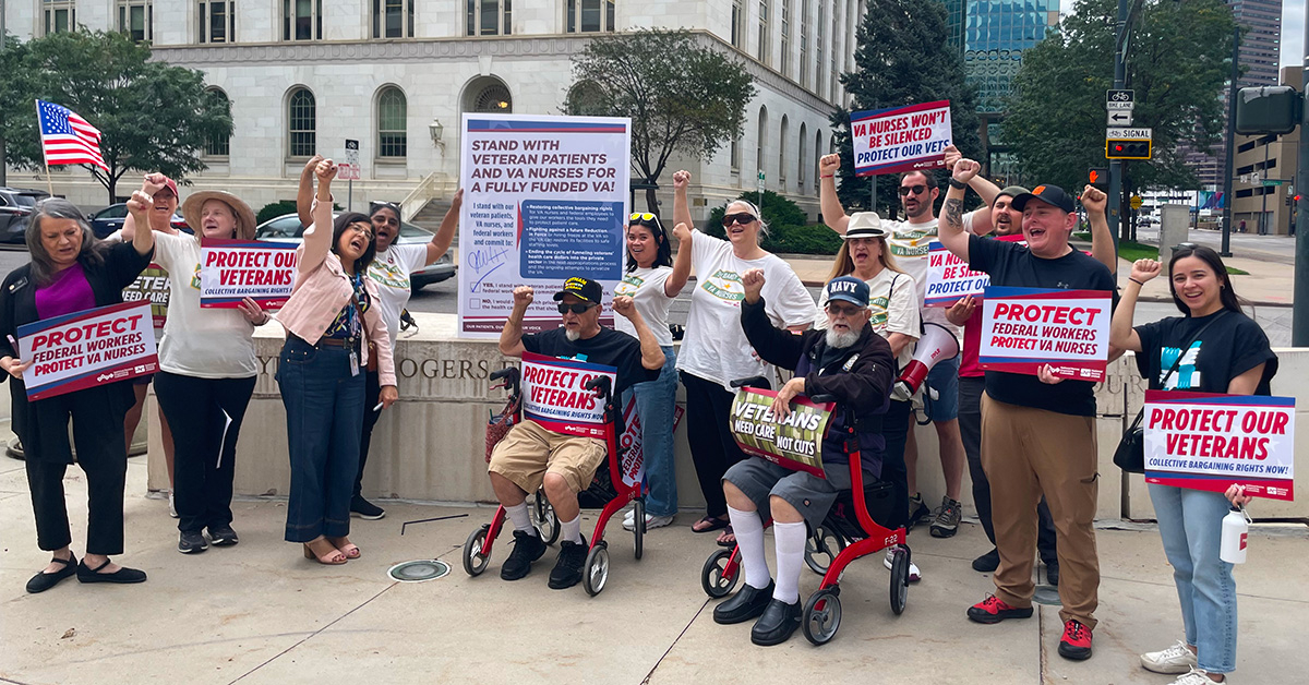 Nurses and veterans at rally, holding signs "Protect Our Veterans"