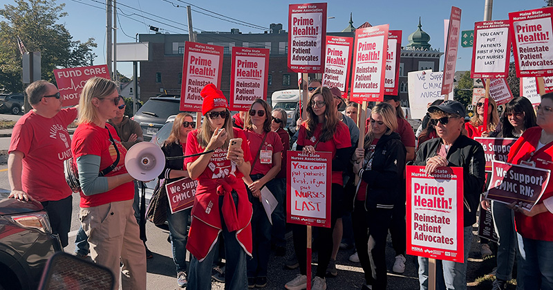 Nurses holding rally outside with signs "Prime Health: Reinstate Patient Advocates"