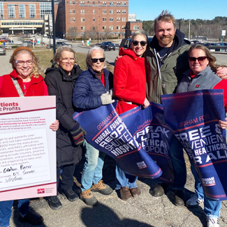 Nurses with Graham Platner, holding signs of support