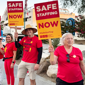 Tenet nurses holding signs and shirt "Safe staffing now" "Safe staffing saves lives"