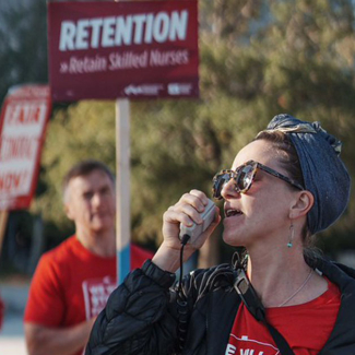 UMC nurses on strike with picket sign that reads "Don't sideline nurses."