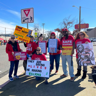 Nurses on strike line holding signs