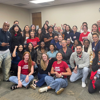 Large group of nurses inside hospital meeting room smiling