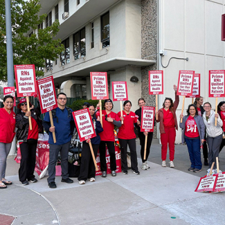 Nurses on strike line holding signs "Prime RNs United for our Patients"