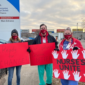 3 nurses hold signs "Ready for Change", "Our Patients Deserve Better", "Nurses Unite"